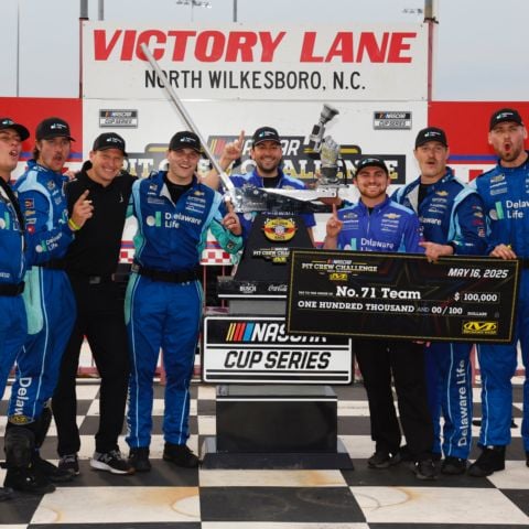 Michael McDowell's No. 71 Spire Motorsports crew, (from left) Rear Tire Changer Ty Boeck, Front Tire Changer Max Marsh, Tire Carrier Luke Bussel, Crew Chief Travis Peterson, Engineer Adam Sturgill, Jackman Dax Hollifield, Fueler Brandon Chapman and Pit Crew Coach Keith Flynn, celebrate after posting a 12.587-second pit stop to win Friday's NASCAR Pit Crew Challenge presented by Mechanix Wear at North Wilkesboro Speedway.