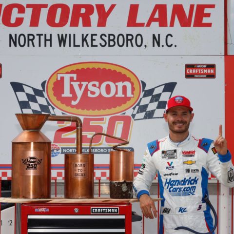 Kyle Larson poses in the winner's circle after winning Saturday's NASCAR CRAFTSMAN Truck Series Tyson 250 at North Wilkesboro Speedway.