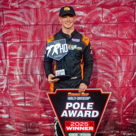Landon S. Huffman holds his pole winner trophy after qualifying first for Saturday's zMAX CARS Tour Late Model Stock Crossroads Harley-Davidson 125. 