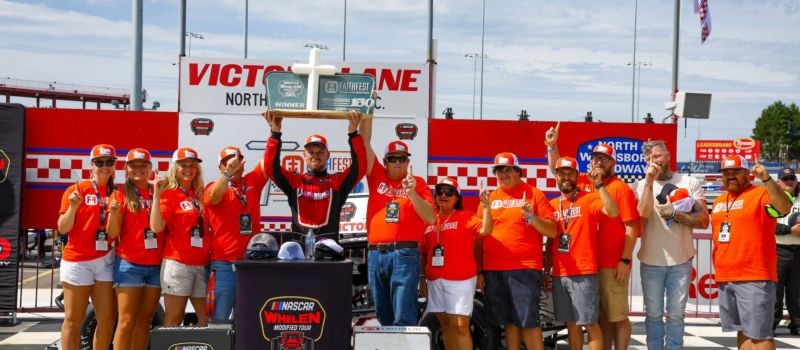 Craig Lutz celebrates his first trip to North Wilkesboro Victory Lane with the FaithFest crew following Sunday’s FaithFest Evangelistic Ministries 150. 
